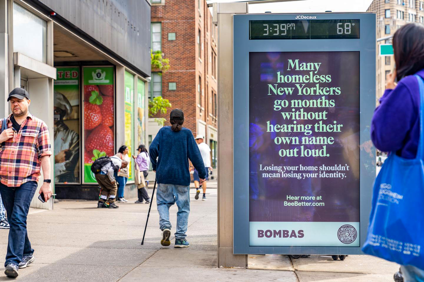 People walking by Bambas campaign on Homelessness in NYC
