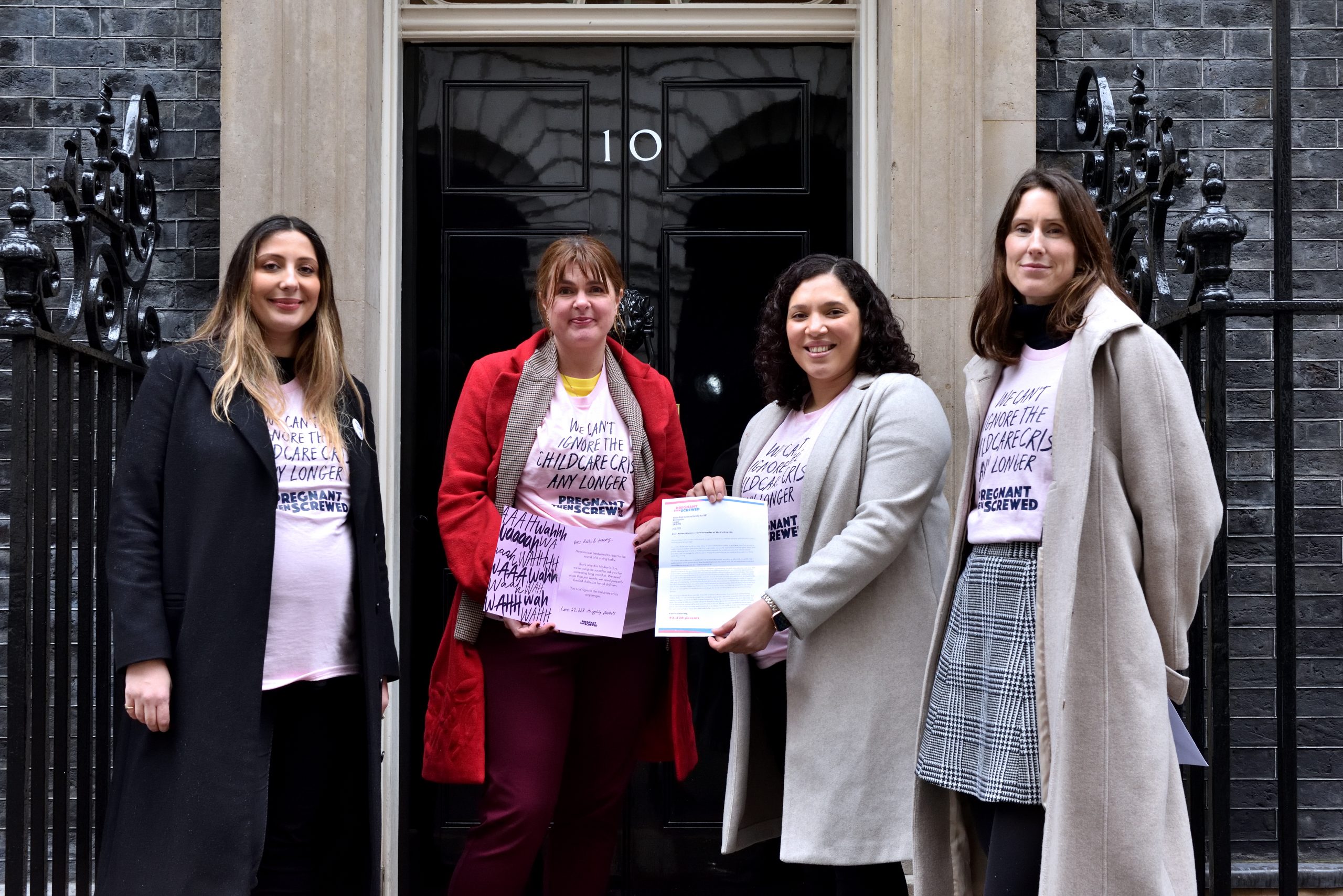 Women holding Saatchi & Saatchi cards