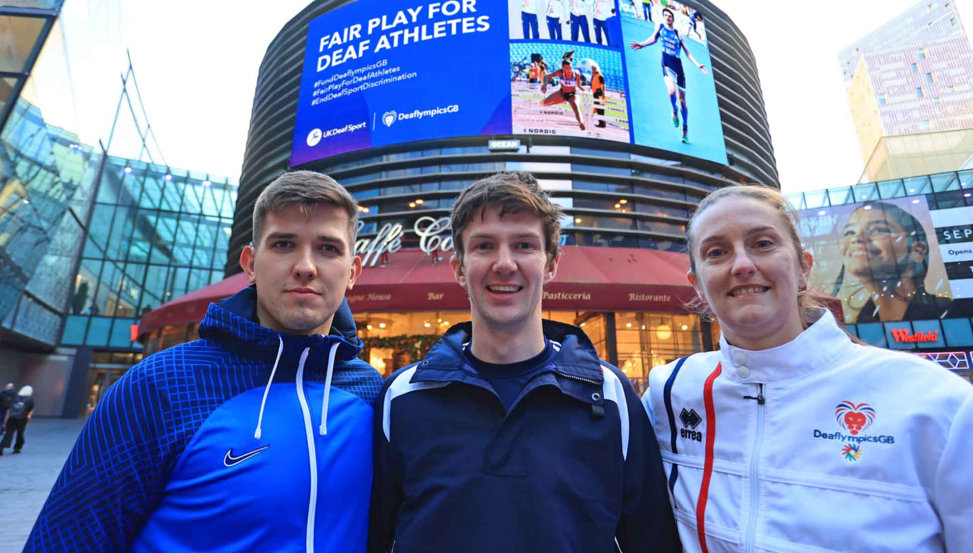 Image copyright Ocean Outdoor. Picture shows athletes (left to right) Nathan Young, Oliver Pritchard and Claire Stancliffe at the launch of their first OOH campaign which calls for Fair Play for Deaf Athletes. UK Deaf Sport is lobbying the Government to end discrimination against elite deaf athletes. 