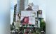 Building facade displaying multiple large Dove billboards promoting a hair mask product