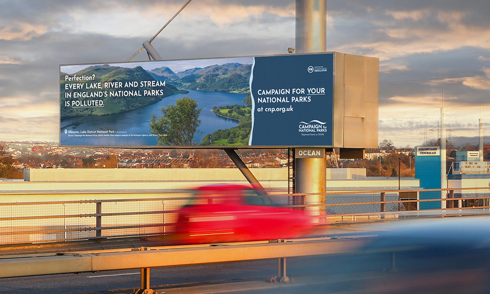 Digital billboard on an overpass displaying the "Campaign for National Parks"
